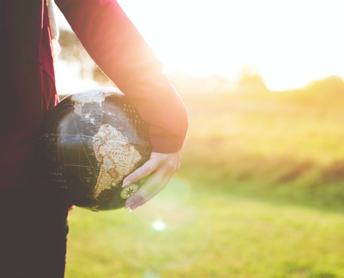 A person standing with the world at their side. They are ready in season and out of season.