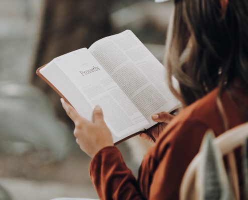 rear-view of a woman reading the scriptures
