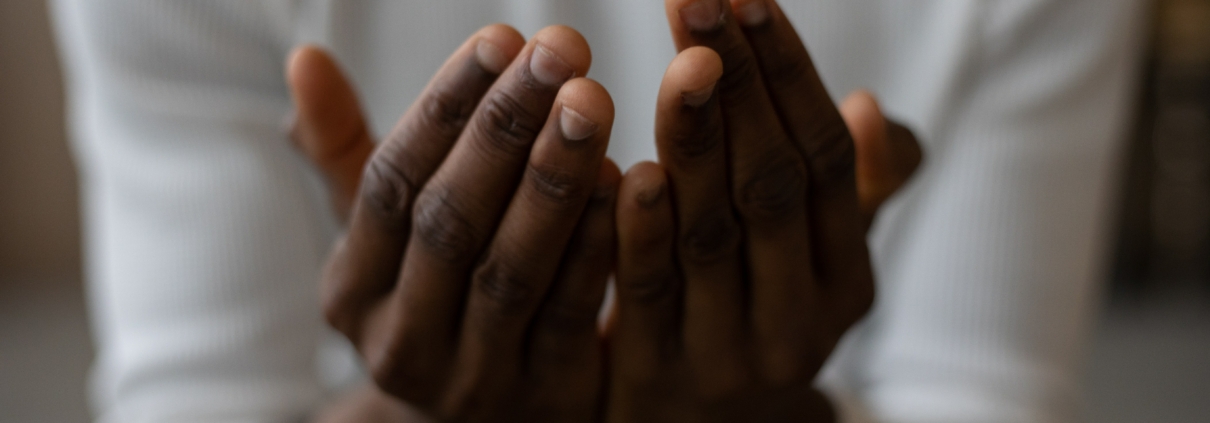 A women with open hands indicating that she is praying