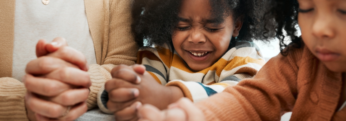 Grandmother praying over children