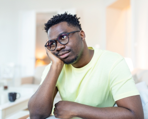 Close up profile view of pensive upset African American man look in distance thinking of personal problems, thoughtful sad biracial male feel depressed lost in thoughts pondering, having dilemma