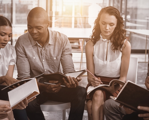 Colleagues discussing during meeting in office