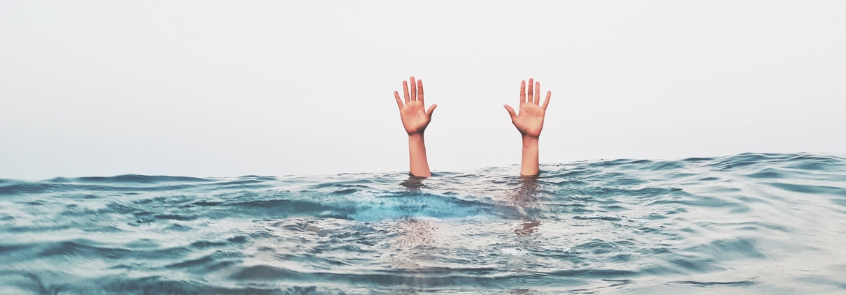 cropped-hands-person-emerging-from-sea-against-clear-sky