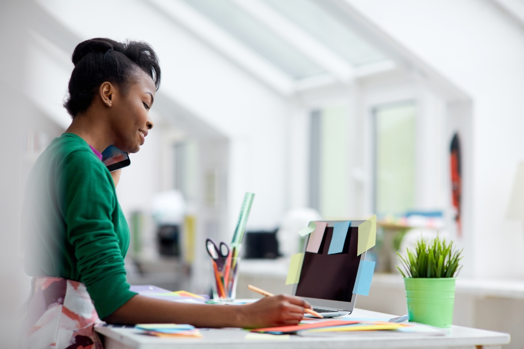 Female designer planning her work and talking by cellphone about Christian workplace character